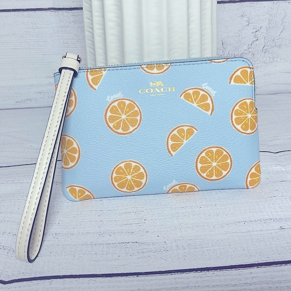 NEW Coach wristlet with orange print 🍊